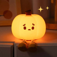 Cute Pumpkin Night Light with a face on a shelf.